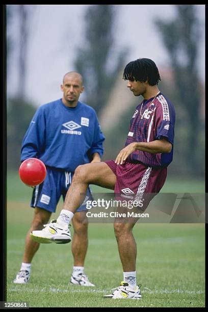 Chelsea player manager Ruud Gullit gets in some practice as new signing Gianluca Vialli of Italy looks on during Viallis first training session with...