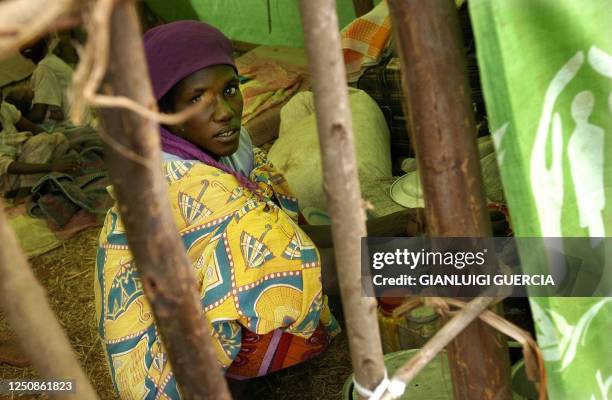 Congolese refugee takes shelter, 19 June 2004, at the Rugombo refugee camp, in Burundi, 20 kms from the Congolese border. Almost 25,000 people have...