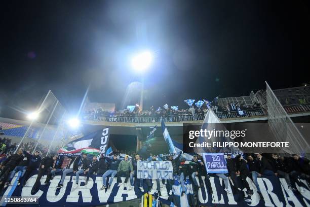 Napoli's supporters celebrate during the Italian Serie A football match between Lecce and Napoli at the Via del Mare stadium in Lecce on April 7,...