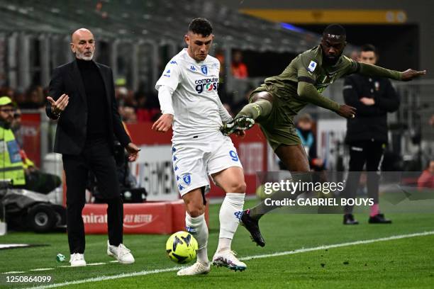 Empoli's Italian forward Roberto Piccoli fights for the ball with AC Milan's British defender Fikayo Tomori during the Italian Serie A football match...