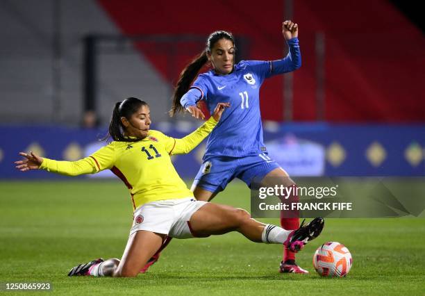 France's midfielder Amel Majri fights for the ball with Colombia's forward Catalina Usme during the women's international friendly football match...