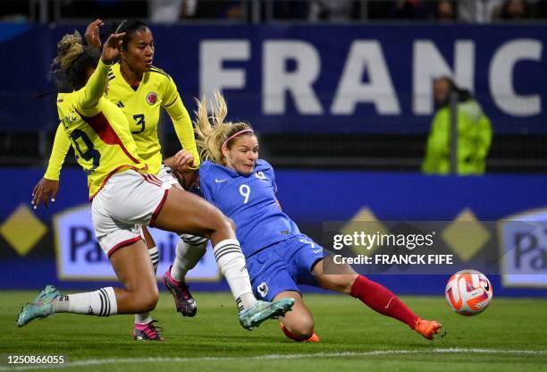 France's forward Eugenie Le Sommer fights for the ball with Colombia's defender Daniela Arias during the women's international friendly football...