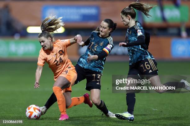 Netherlands' Victoria Pelova fights for the ball with Germany's Sara Dabritz and Tabea Wasmuth during the women's international friendly football...