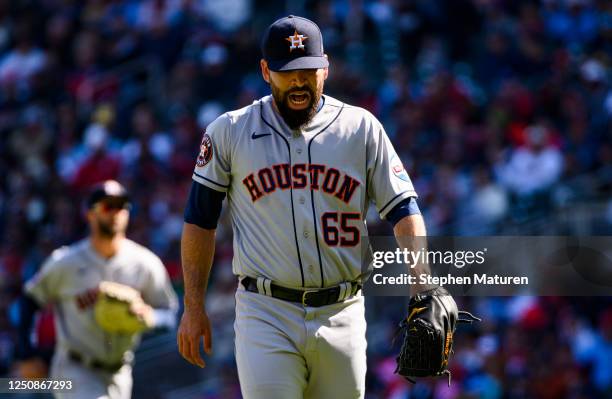 Jose Urquidy of the Houston Astros reacts as he walks to the dugout after pitching during the first inning of the home opener against the Minnesota...