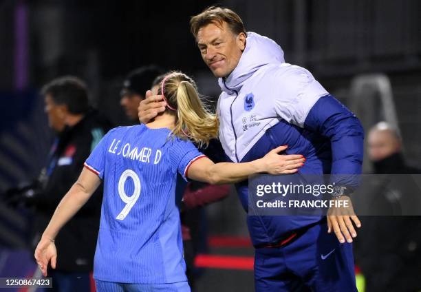 France's forward Eugenie Le Sommer is congratulated by France's head coach Herve Renard after scoring a goal during the women's international...