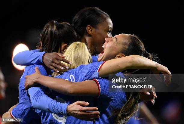 France's defender Sakina Karchaoui congratulates France's forward Eugenie Le Sommer after scoring a goal during the women's international friendly...
