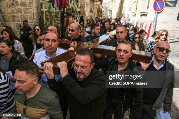 Christians carry wooden crosses along the Via Dolorosa in Jerusalem's Old City during the Catholic Good Friday procession. Christian pilgrims took...