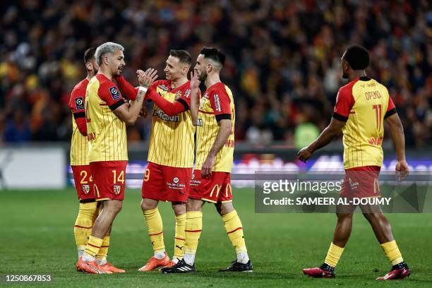 Lens' Argentine defender Facundo Medina celebrates with teammates after scoring a goal during the French L1 football match between RC Lens and RC...
