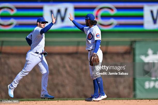 Ian Happ of the Chicago Cubs and Dansby Swanson celebrate after defeating the Texas Rangers 2-0 at Wrigley Field on April 07, 2023 in Chicago,...