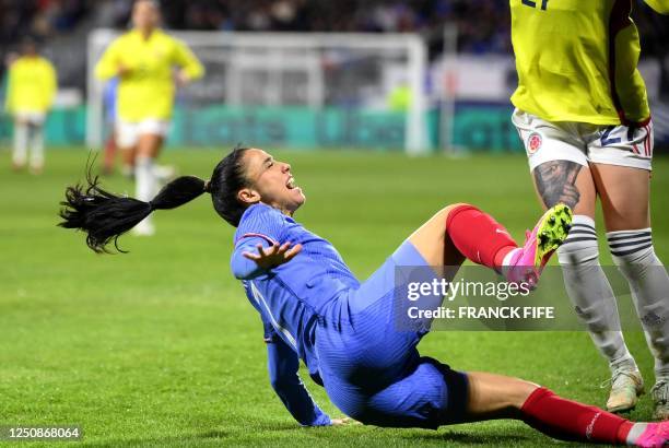 France's defender Sakina Karchaoui is tackled by Colombia's midfielder Ingrid Guerra during the women's international friendly football match between...