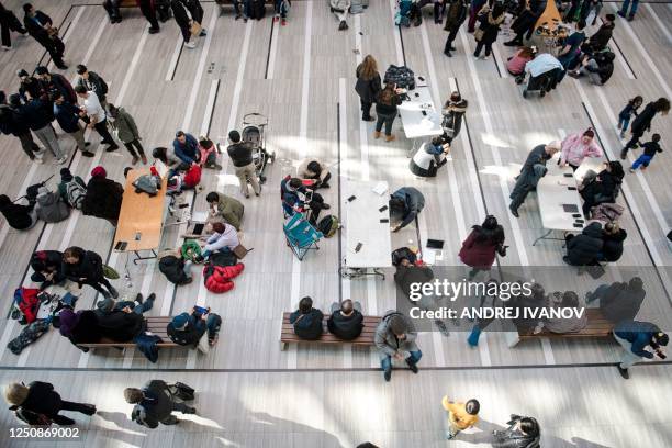 People charge their phones at stations set up in the CF Fairview Mall on April 07 in Montreal, Canada after freezing rain hit parts of Quebec and...
