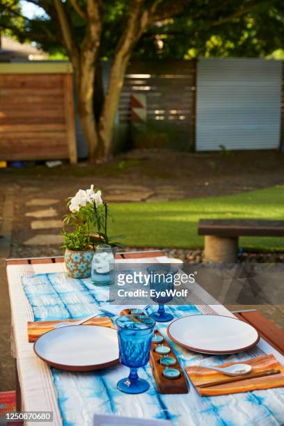 a table setup for a formal dinner in a back yard at sunset. - formal dining stock pictures, royalty-free photos & images