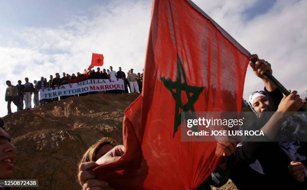 People demonstrate against the visit of Spain's King Juan Carlos to the Spanish North African enclave of Ceuta, at the border between Morocco and...