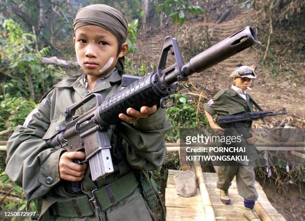 Children from the Karen National Union insurgent army hold assault weapons during celebrations marking the 51st anniversary of the army's rebellion...