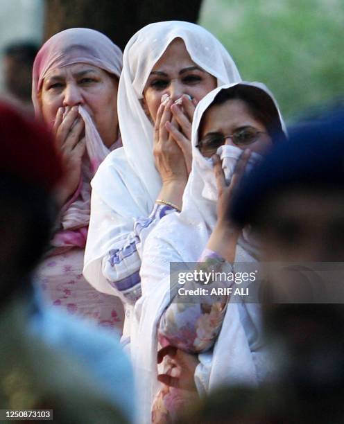 Female Pakistani relatives of Colonel Haroon Islam cry during his funeral ceremony in Lahore, 10 July 2007. Haroon was killed during fierce clashes...