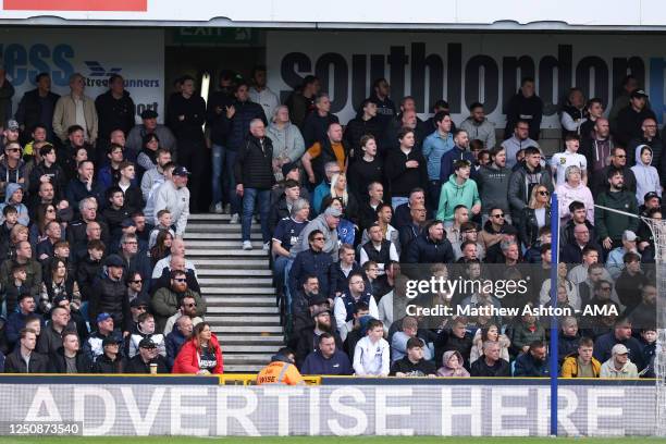 Millwall fans in front of an LED Advertising board saying Advertise Here during the Sky Bet Championship between Millwall and Luton Town at The Den...