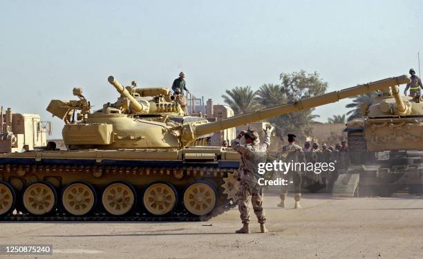 An Iraqi soldier guides a soviet-designed T-72 tanks at an army compound in al-Taji, north of Baghdad, 12 November 2005. Iraq announced it had...