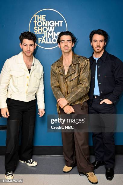 Episode 1832 -- Pictured: Nick Jonas, Joe Jonas, and Kevin Jonas of musical group Jonas Brothers pose together backstage on Friday, April 7, 2023 --