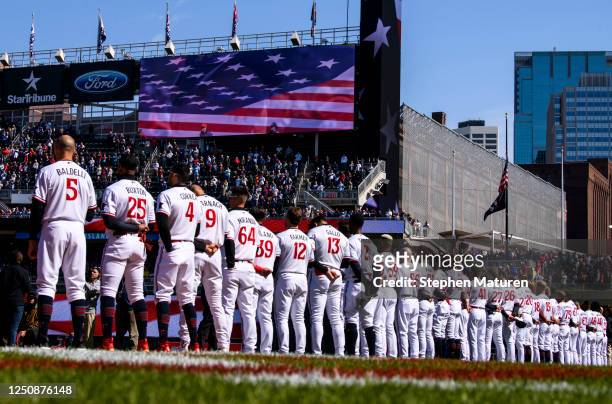 Minnesota Twins players line up for the National Anthem before the home opener against the Houston Astros at Target Field on April 7, 2023 in...