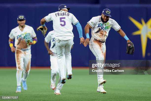 Wander Franco of the Tampa Bay Rays high fives Manuel Margot to celebrate a win over the Oakland Athletics in a baseball game at Tropicana Field on...