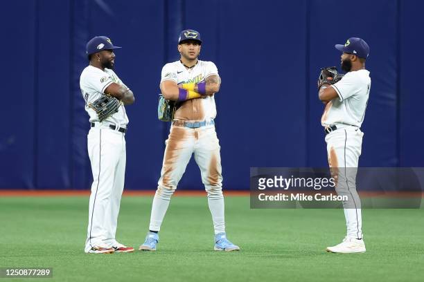 Randy Arozarena of the Tampa Bay Rays, left, Jose Siri, and Manuel Margot celebrate a win over the Oakland Athletics in a baseball game at Tropicana...