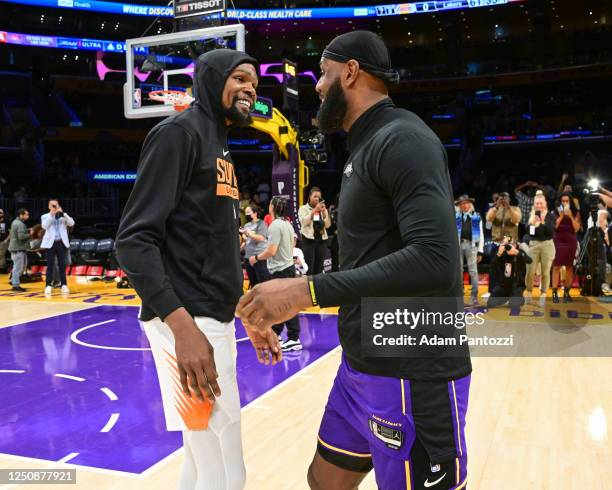 LeBron James of the Los Angeles Lakers and Kevin Durant of the Phoenix Suns embrace before the game on April 7, 2023 at Crypto.Com Arena in Los...