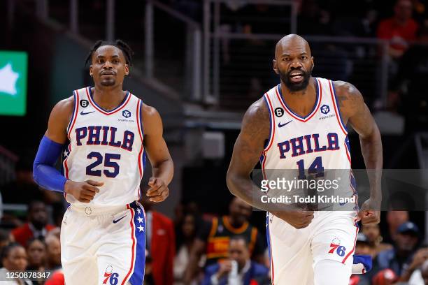 Dewayne Dedmon reacts with Danuel House Jr. #25 of the Philadelphia 76ers during the second half against the Atlanta Hawks at State Farm Arena on...