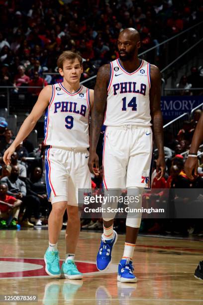 Mac McClung and Dewayne Dedmon of the Philadelphia 76ers talk during the game against the Atlanta Hawks on April 7, 2023 at State Farm Arena in...