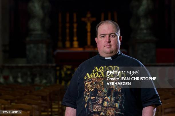 Father Bertrand Monnier wearing a tshirt of Swedish death metal band Amon Amarth, poses after the Palm Sunday mass at Notre-Dame Cathedral in Verdun,...