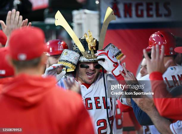 Los Angeles Angels center fielder Mike Trout in the dugout wearing a samurai helmet after hitting a two run home run in the first inning of an MLB...