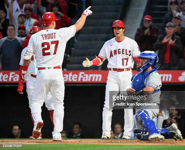 Los Angeles Angels designated hitter Shohei Ohtani waits at home plate for center fielder Mike Trout after Trout hit a two run home run in the first...
