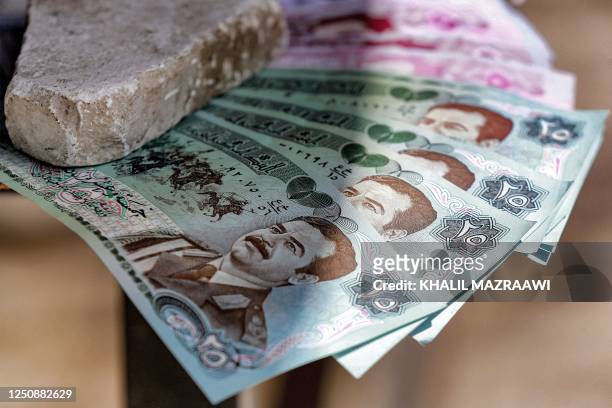 In this picture taken on April 6 old Iraqi dinar banknotes showing the image of Iraq's late ousted dictator Saddam Hussein are displayed at a shop in...