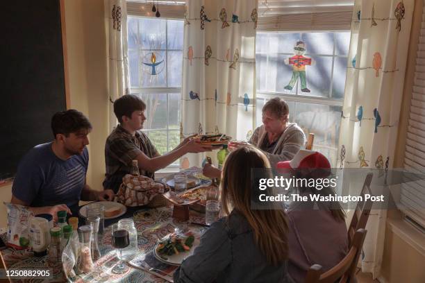 The Briggle family eats dinner together at their home in TX on March 19, 2023.