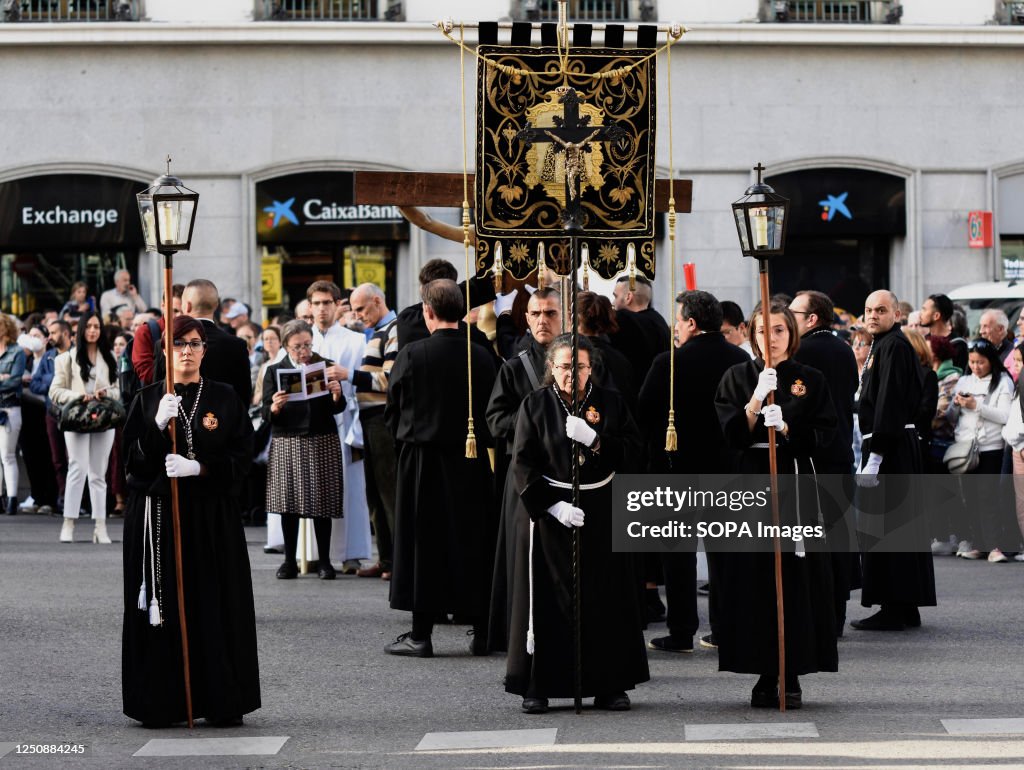 Penitents wear a black habit with a terrine of the same...