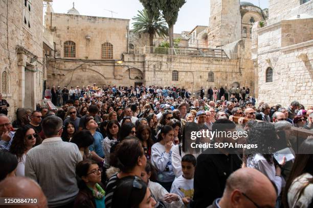 Crowd of Christians pilgrims gather outside the Church of The Holy Sepulchre in Jerusalem at the end of the Via Dolorosa, the pilgrimage route which...