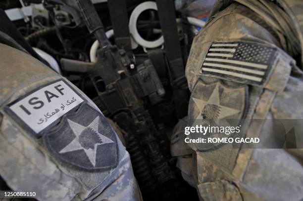 In this photograph taken October 8 US Army soldiers from the 5th Stryker Brigade Combat Team, 2nd Infantry Division wear the insignias of their unit...