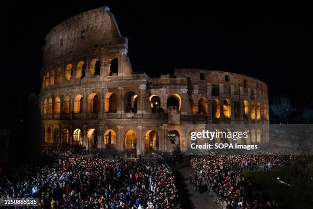 Thousands of the faithful wait outside the Roman Colosseum for the Stations of the Cross to begin on Holy Friday. Thousands of the faithful crowded...