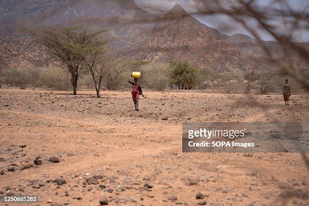 Woman transporting water to her village in Turkana. Climate change in East Africa is causing the worst drought in its history. It has not rained in...
