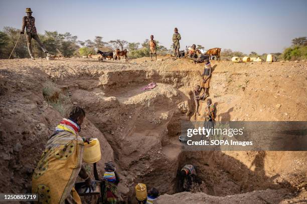 Turkana people sourcing water from a well to survive drought. Climate change in East Africa is causing the worst drought in its history. It has not...