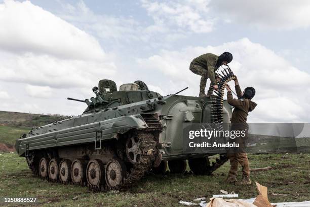 Ukrainian soldiers carry ammunition for a BMP during a training as Russian-Ukrainian war continues in Donetsk Oblast, Ukraine on April 07, 2023.