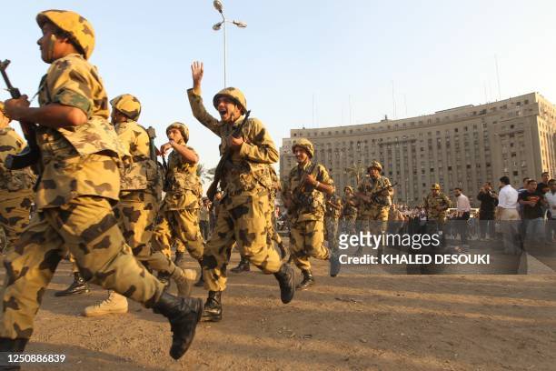 Egyptian military police helped by civilians arrive to contain a some dozen people who attemped to stop citizens and the police from opening Tahrir...