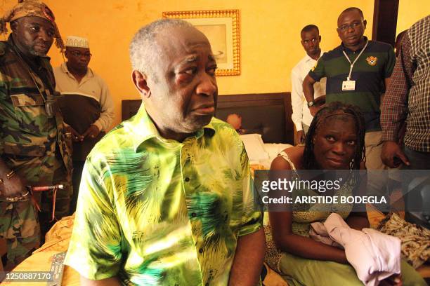 Ivory Coast strongman Laurent Gbagbo and his wife Simone sit on a bed at the Golf Hotel in Abidjan after their arrest on April 11, 2011. Ivory Coast...