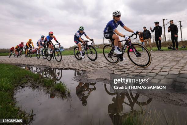 Fenix-Deceuninck team's Belgian rider Marthe Truyen cycles in a breakaway over the first cobblestone sector in Hornaing, northern France, during the...