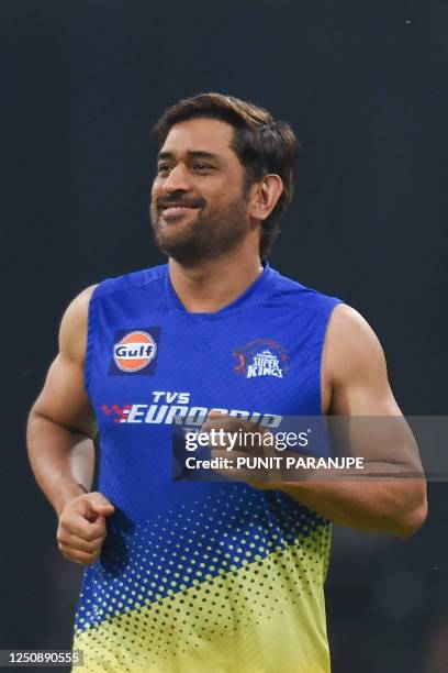 Chennai Super Kings' captain Mahendra Singh Dhoni warms up before the start of the Indian Premier League Twenty20 cricket match between Mumbai...