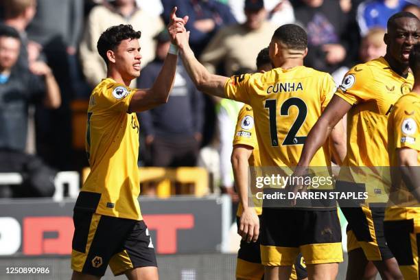 Wolverhampton Wanderers' Brazilian midfielder Matheus Nunes celebrates with teammates after scoring the opening goal of the English Premier League...