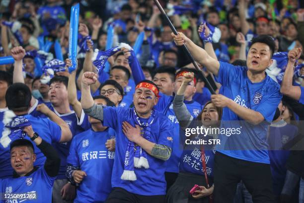 Wuhan Three Towns' fans cheer during the 2023 Chinese Football Association Supercup football match between Wuhan Three Towns FC and Shandong Taishan...