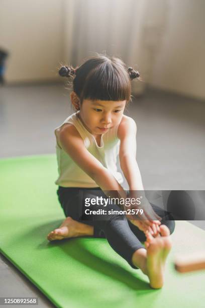 asian cute girl doing fitness exercises at home - leg stretch girl stock pictures, royalty-free photos & images