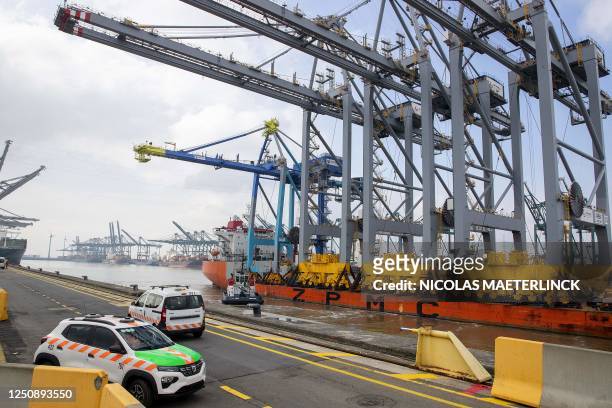 This photograph shows a ship arriving with three new ship-to-shore cranes of DP World during a press event in a harbour in Antwerp, on April 8, 2023....