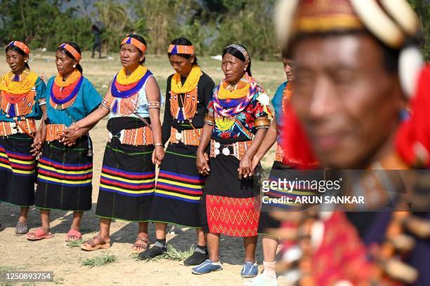 The Konyaks perform their tribal dance in Longwa village, in the northeast Indian state of Nagaland on April 8, 2023.