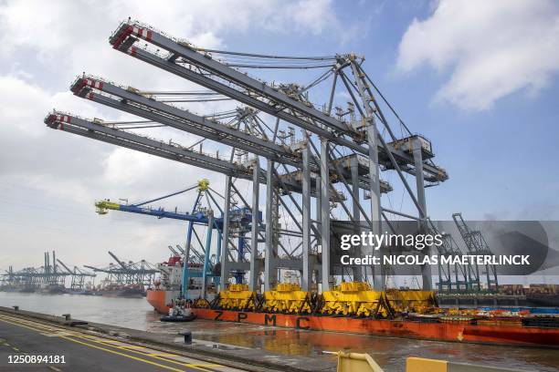 This photograph shows a ship arriving with three new ship-to-shore cranes of DP World during a press event in a harbour in Antwerp, on April 8, 2023....